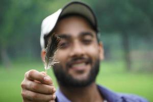 a boy with feather playing with feather photo