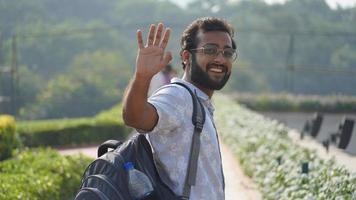 portrait of a man smiling and saying good bye photo