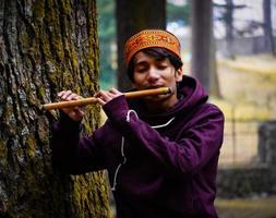 man with golden flute image photo