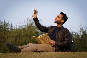 Study abroad concept man with aeroplane and books photo