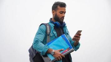 young boy using mobile phone at collage in withe background photo