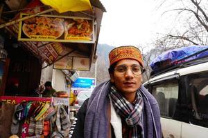 a boy in market near hilly area photo