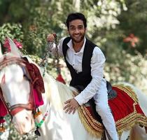 Indian groom riding baraat horse photo