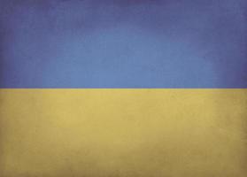 Ukrainian flag blue and yellow colored old paper background with vignette and copyspace photo