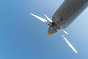 Airplane propeller of military aircraft, copy space. Blue sky background. photo