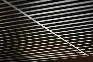Office grille ceiling. Modern black metal grille ceiling, suspended covering. Abstract design texture. photo