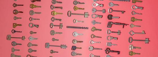 Keys set on pink background. Door lock keys and safes for proper photo
