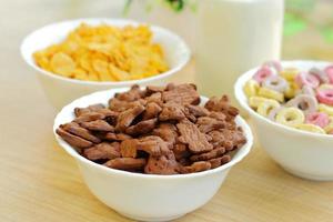 Bowls with different sorts of breakfast cereal products, white bowls with morning meal photo