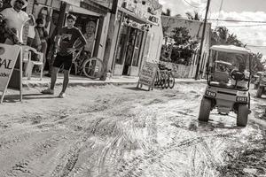 Holbox Mexico 22. December 2021 Golf cart buggy cars carts muddy street village Holbox Mexico. photo