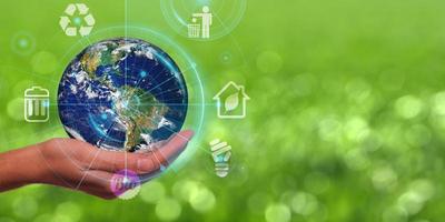 Earth Day is held in hands. Energy conservation, environmental preservation, and long-term development are all concepts that are being explored. Ecology concept photo