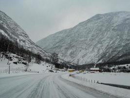 Driving through snowy road and winter landscape in Norway. photo