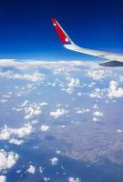 Bangkok Thailand 21. May 2018 Flying with Nepal Airline above clouds over countryside of Thailand. photo