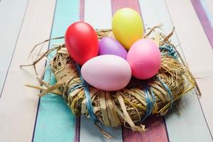 easter concept with multi color egg on pink background. photo