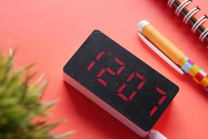 digital clock on red background top down photo
