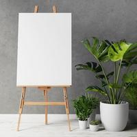 Blank canvas on wooden easel with plant photo