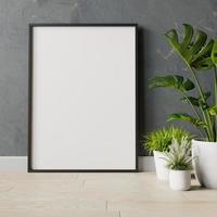 marco en blanco en la pared con planta foto
