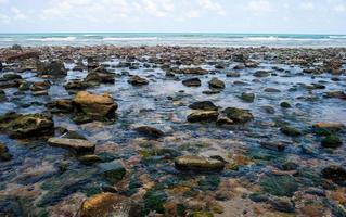 Beautiful seaside boulders and bright sea water photo