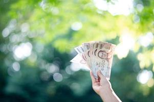 Hand and money, multiple banknotes of financial executives For business and daily spending photo