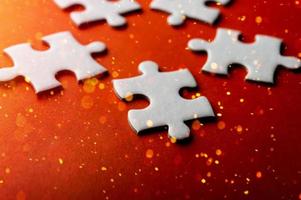 White puzzles placed on an orange background Represent the unity and power of successful people photo