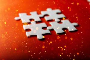 White puzzles placed on an orange background Represent the unity and power of successful people photo