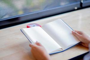 Hands and books that are laid bare with space In the morning room Book reading concept photo