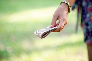 Hand and money, multiple banknotes of financial executives For business and daily spending photo