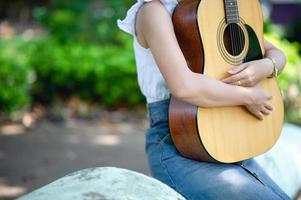 Musician hands and acoustic guitars, musical instruments with very good sound Musical instrument concept photo