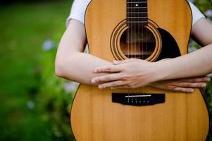 The woman plays the guitar happily. Cute, bright, happy to play music that loves music concepts photo