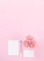 Top view, flat lay, mock up, copy space, handwritten greeting card template isolated with pale pink background, idea concept of thanks, wishes, craft carnations bouquet photo
