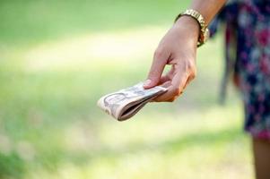 Hand and money, multiple banknotes of financial executives For business and daily spending photo