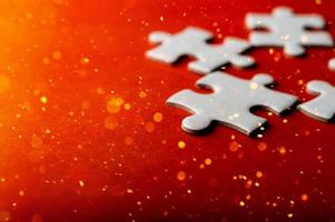 White puzzles placed on an orange background Represent the unity and power of successful people photo
