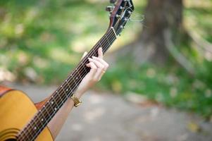 Musician hands and acoustic guitars, musical instruments with very good sound Musical instrument concept photo