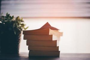 The book is overlaid on the top of the table. Reading concept photo