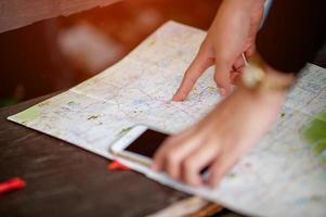 Hand and map of tourists trekking for accuracy. photo