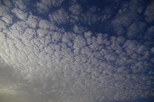 many small clouds on blue sky photo