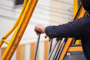 construction worker controls of lifting crane photo