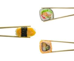 Sushi in chopsticks isolated on white background photo