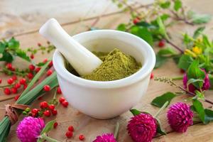 Fresh herbs powder in the mortar, alternative medicine photo