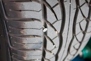 metallic nail in car tyre photo