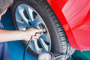 Tire pressure checking by car mechanic photo