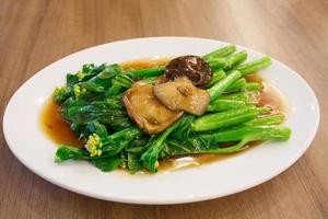 Stir-fried chinese broccoli and shiitake mushroom in oyster sauce photo