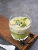 Avocado Milk Cheese Dessert is made from avocado, jelly, cheese, basil seeds, sweetened condensed milk and evaporated milk. Served in a glass. Space for text