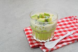 Avocado Milk Cheese Dessert is made from avocado, jelly, cheese, basil seeds, sweetened condensed milk and evaporated milk. Served in a glass. Space for text photo