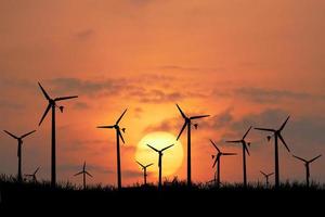 Wind turbines produce electricity in the evening. photo