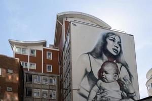 BRISTOL, UK, 2019. Woman and baby portrait Graffiti on a wall  in Bristol on May 14, 2019 photo