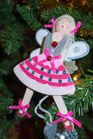 EAST GRINSTEAD, UK, 2013. Funky angel decoration hanging on a christmas tree photo