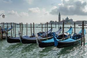 Gondolas moored at the entrance to the Grand Canal photo
