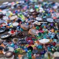 A group of randomly scattered beads, buttons and marbles photo