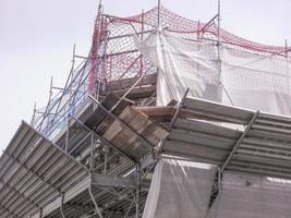 Temporary scaffold for construction works at building site photo