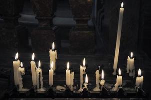 lit candles in a church photo